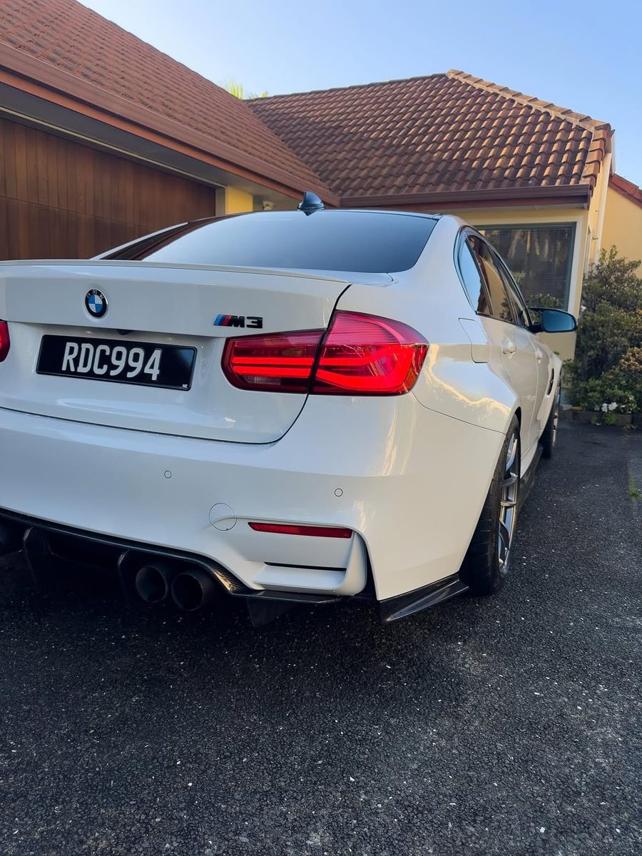 Pearl white BMW M3, rear three-quarter, after detail